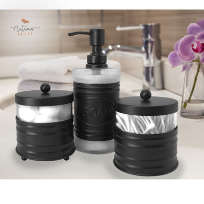 Black Metal Bathroom Set with 2 Apothecary Jars and 1 Soap Dispenser on a Clean Bathroom Counter with Flower