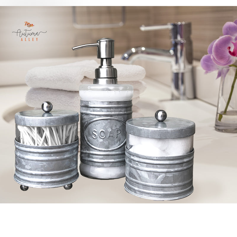 Galvanized Metal Bathroom Set with 2 Apothecary Jars and 1 Soap Dispenser on a Clean Bathroom Counter with Flower